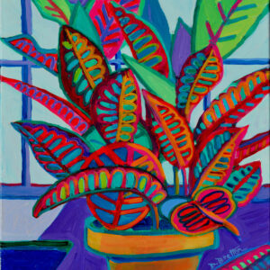 A very colorful plant in an orange pot sits on a desk in front of a large window. The leaves of the plant look patterned with rich red outlines on every vein of each leaf. One leaf lies on the desk. the leaves further in the background are purple and green, complimenting the hot colors outlining the leaves in the foreground.