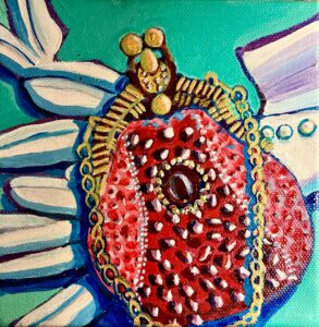 A vintage, red-beaded purse with a golden clasp and golden metal chain linked strap sit atop white opera gloves. Three buttons of one of the gloves is visible.